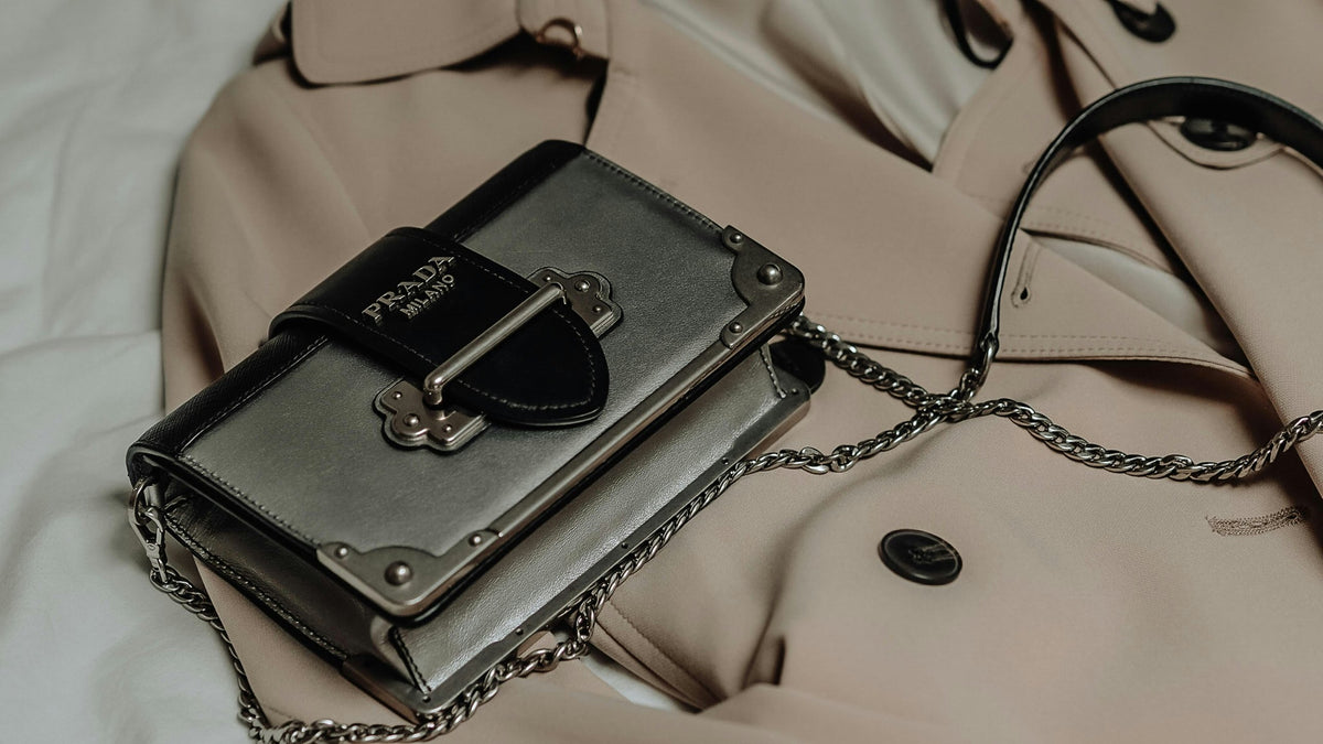 Prada Cahier chain bag on a beige trench coat
